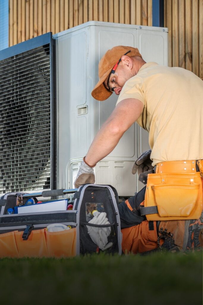 HVAC Technician Worker Fixing Heat Pump at House